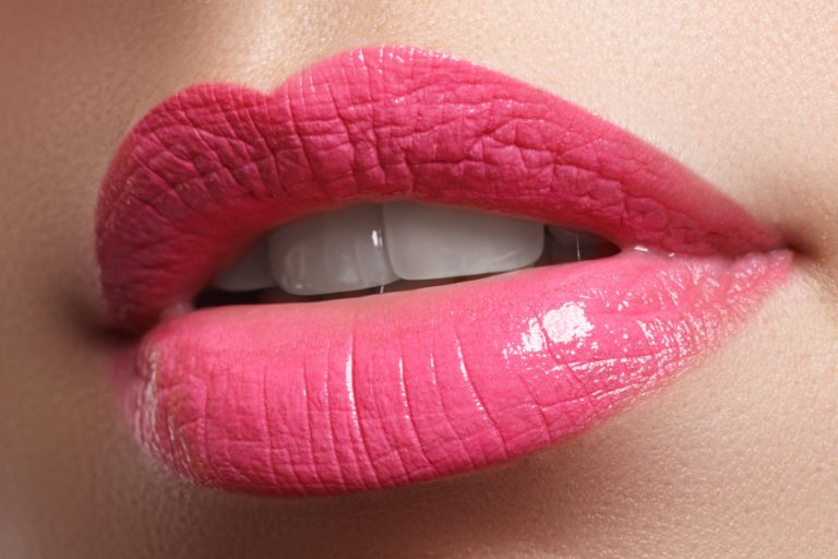 Female lips with permanent makeup, close-up view